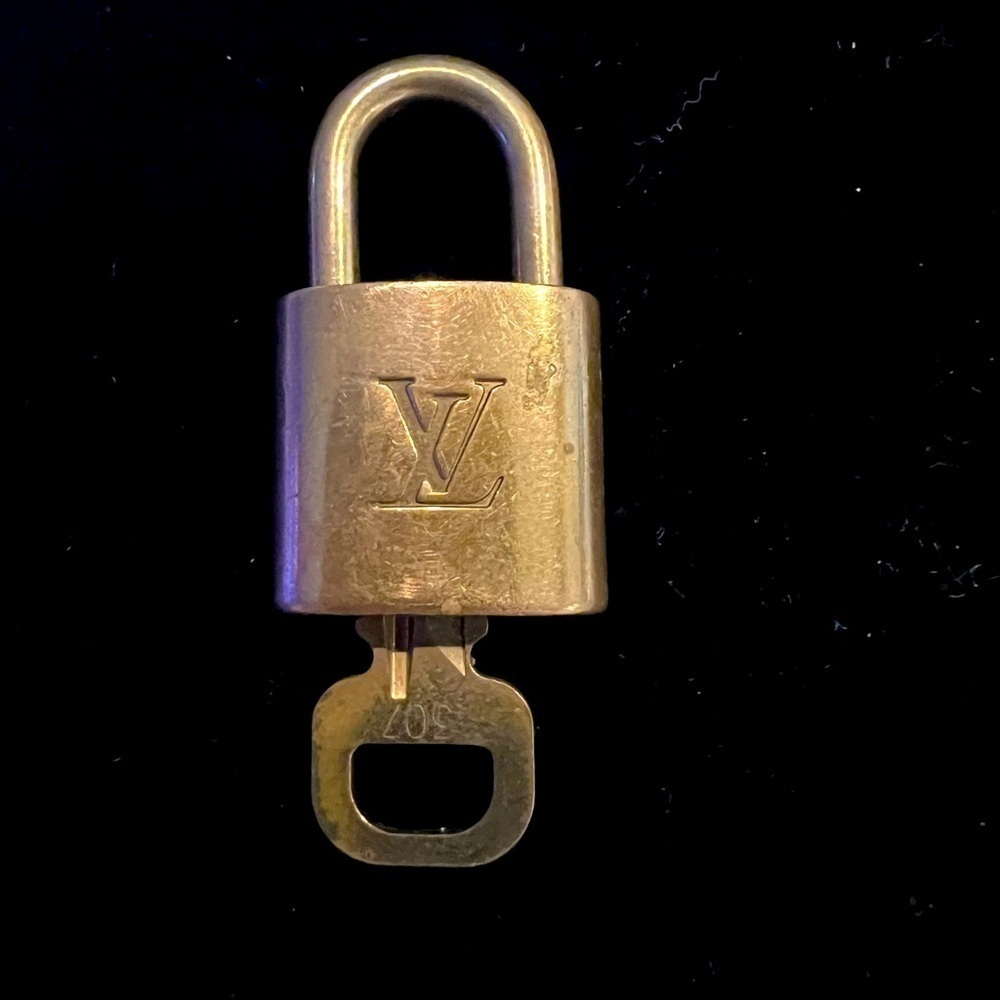 307 Louis Vuitton lock and key, has wear and is numbered 307.